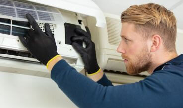 Technician performing an ac repair for a home in Quogue, NY